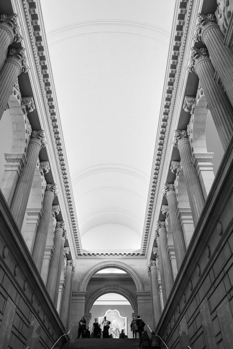 A stunning black and white view of neoclassical architecture in a New York museum.