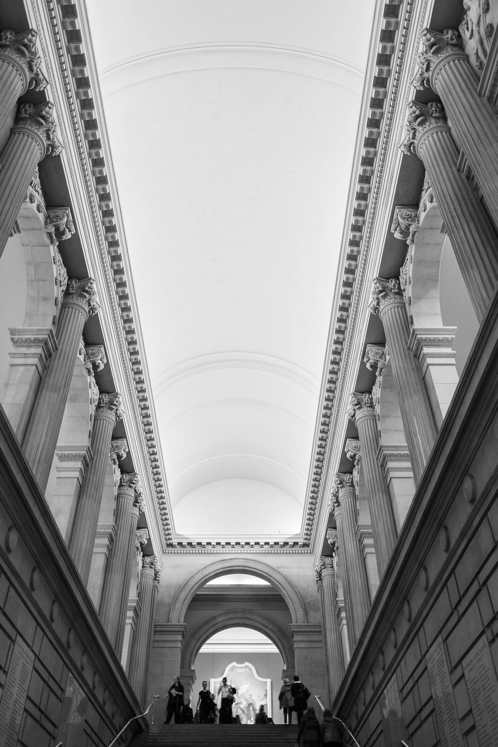 A stunning black and white view of neoclassical architecture in a New York museum.