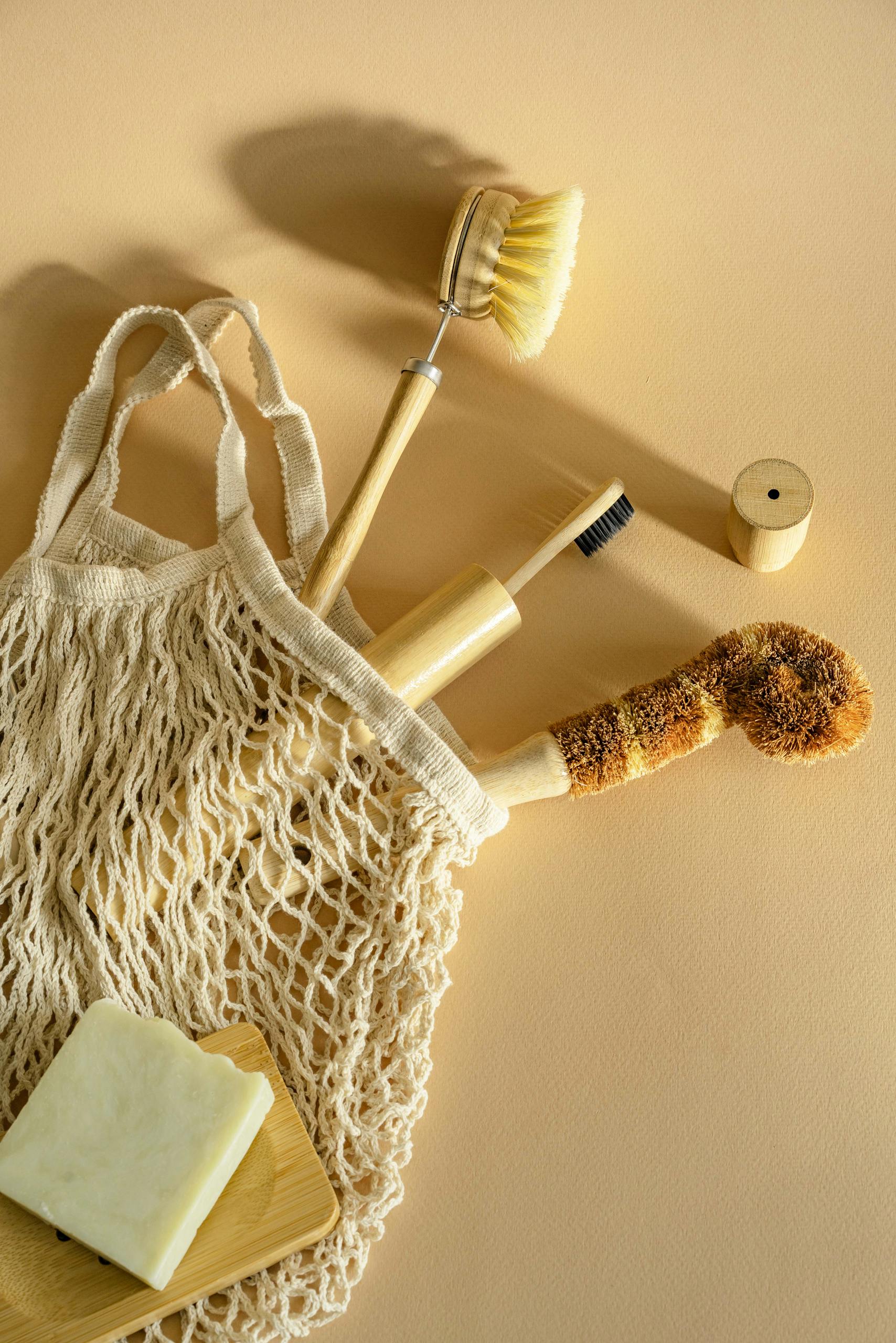 Natural wooden and bristle cleaning brushes with soap in a net bag
